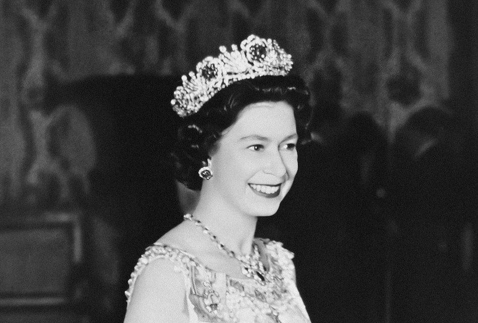 a black and white photo of a woman wearing a tiara